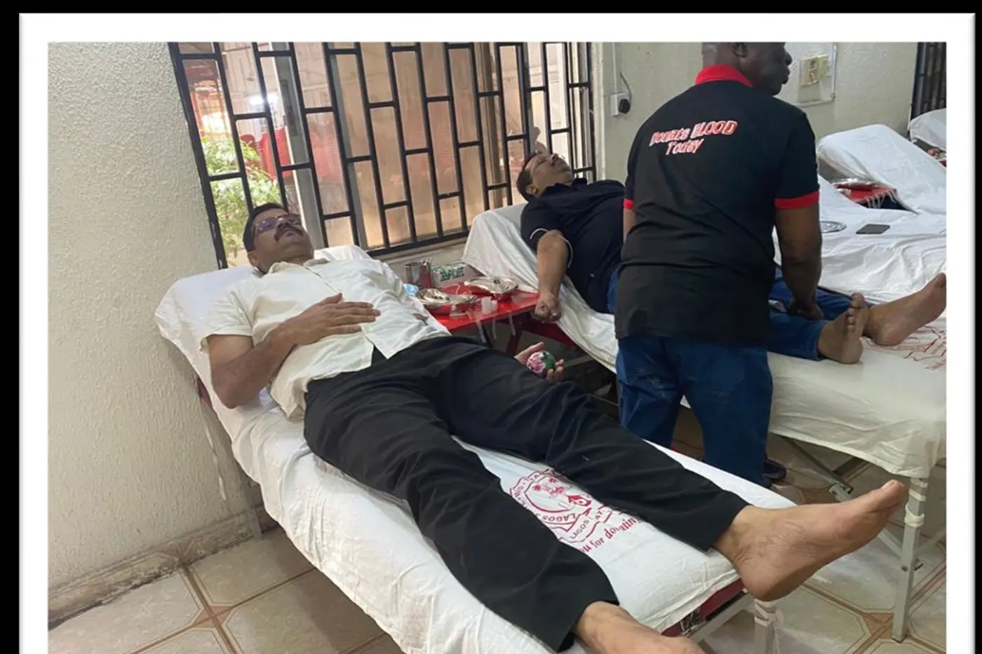 A donor giving blood at a club-run donation drive.