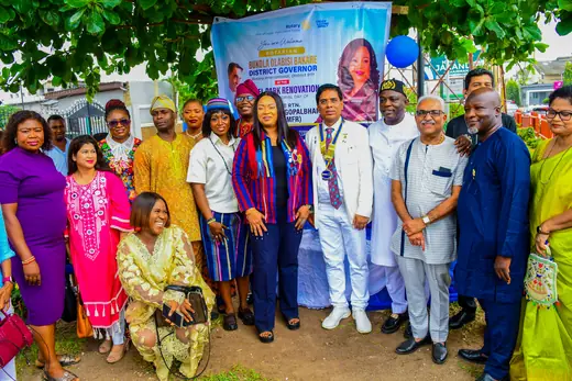 Members and visiting Rotarians standing together after the ceremony.