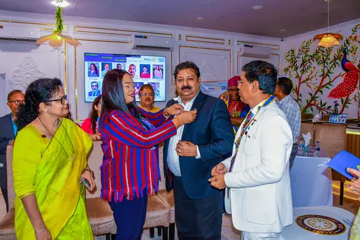 An induction at the fellowship, the collar being fastened by two members.